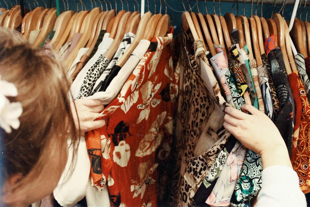 women looking through clothes on a rack