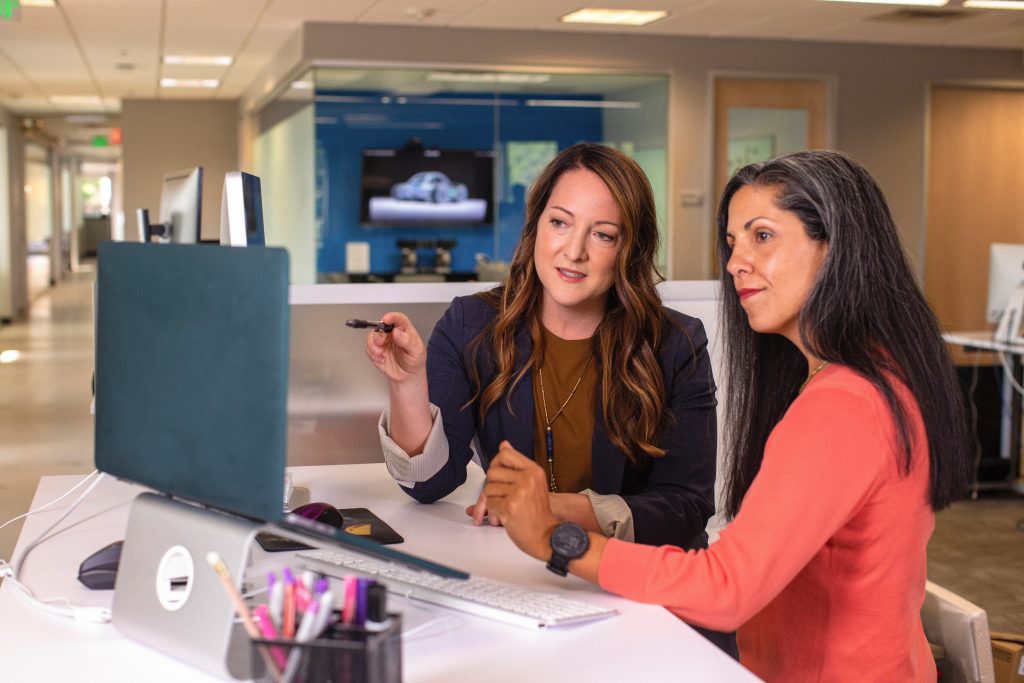 image of women in an office pointing at staring at a desktop screen